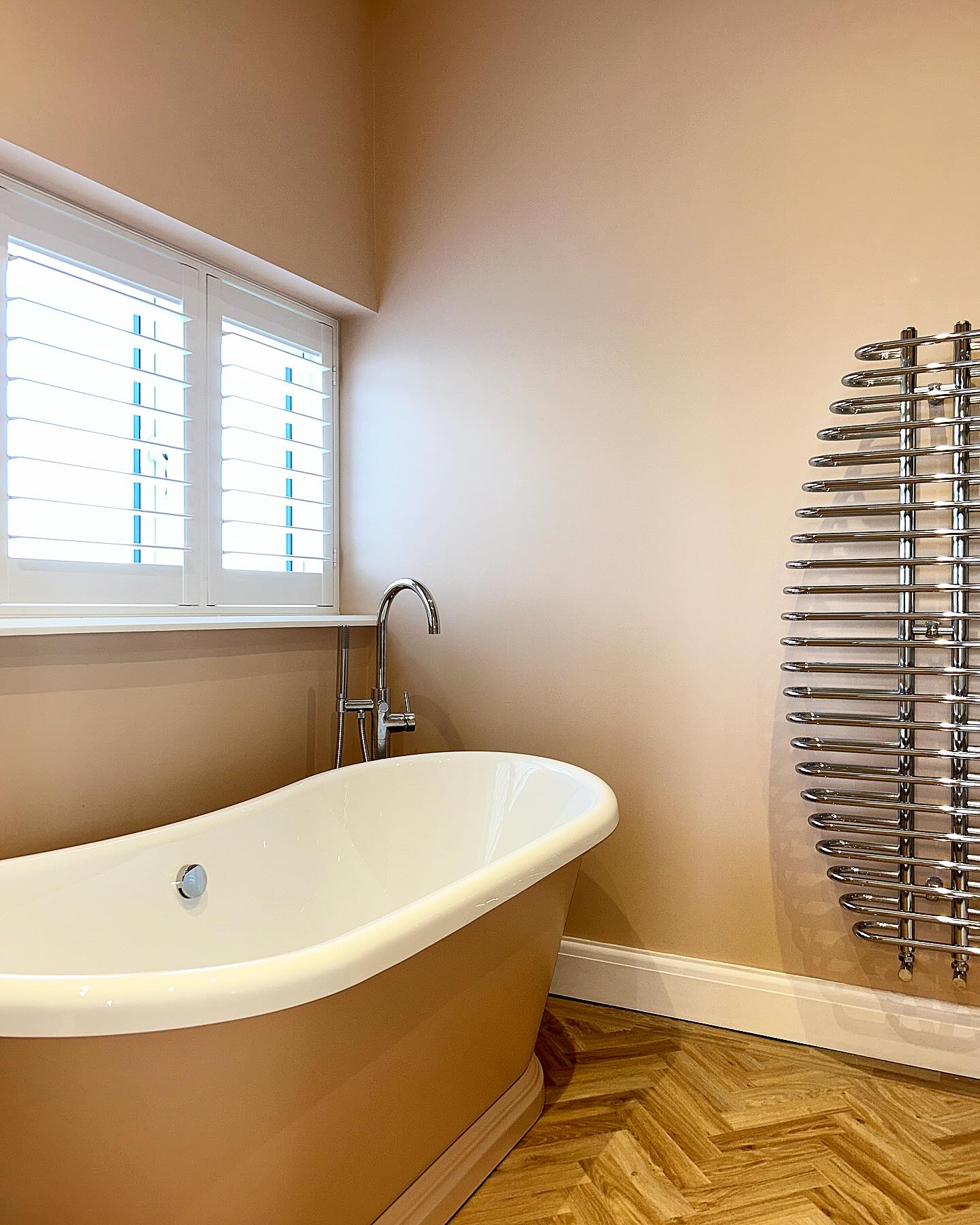 Slipper bath on a herringbone timber floor in an Essex bathroom renovation