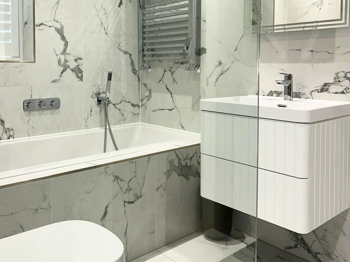Light marble bathroom fitted in Epping, Essex by Plumbers ESX