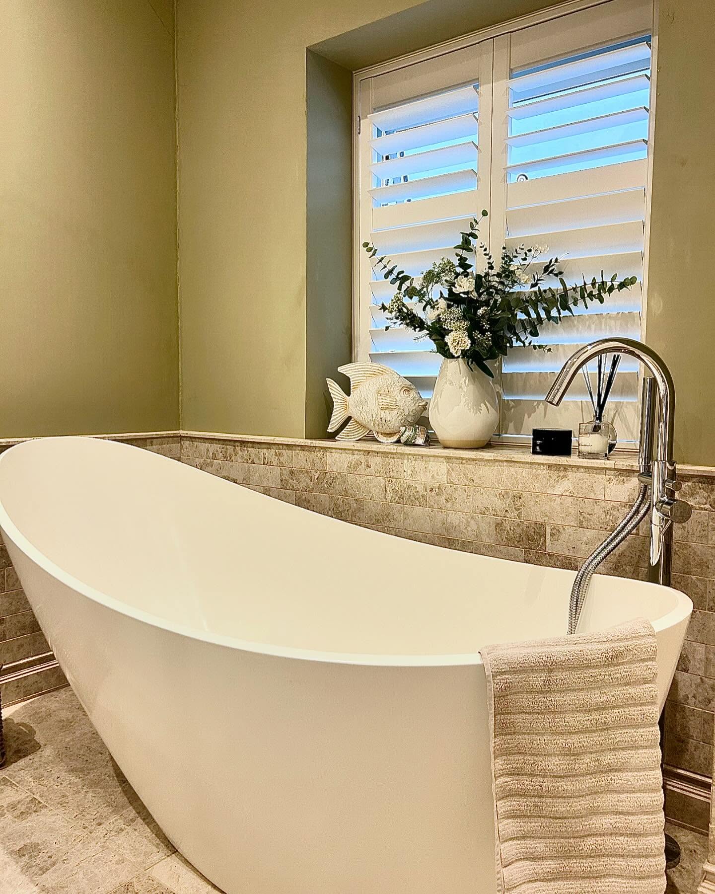 Freestanding bath in an olive green bathroom renovation in Essex by Plumbers ESX